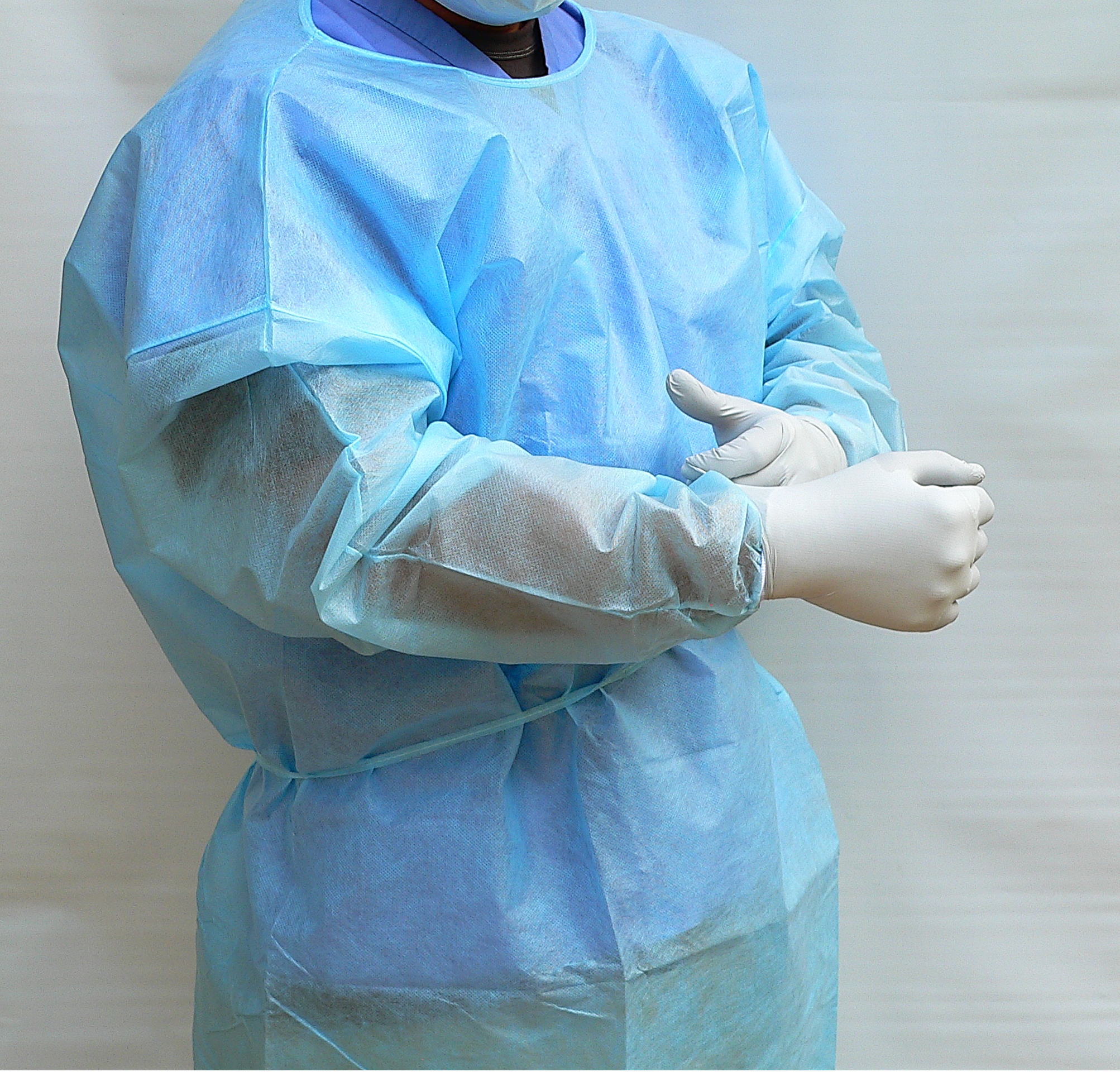 Disposable PE coated level 2 isolation gowns with knit cuffs. Blue color.